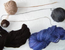 a range of home-spun yarns, clockwise from top left: camel & silk; bamboo; merino & silk; shetland & alpaca; jacob's sheep