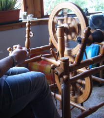 'chair' wheels were originally made from old chairs turned upside down; made of oak and held together with pegs, this one has 2 wheels linked together with a belt, to save space