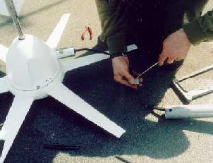 Installation: the installer is here connecting the wires that run down the mast to the batteries and inverter.