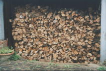 stacking the split logs under cover for at least one summer will reduce the moisture content to around 25%