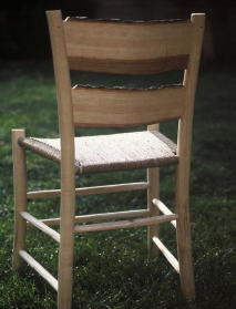 ladderback chair: a traditional green wood rustic furniture project; the bark has been left on some pieces, and the seat is made of woven sea-grass