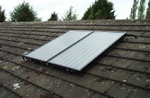Two solar hot water panels on a domestic roof; they are thicker than solar electric panels, but only protrude about 10cm from the roof