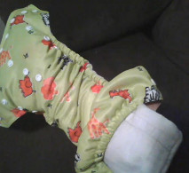 inserting absorbent material into a pocket nappy