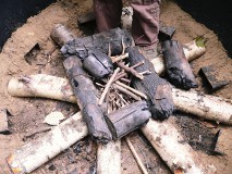 starting to stack wood in the kiln, with kindling in the middle