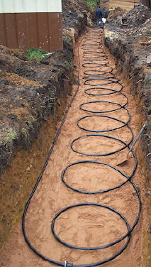 The ground loop collector pipe being laid in a trench