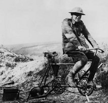 a soldier in France during WWI, powering a field radio with a bike generator