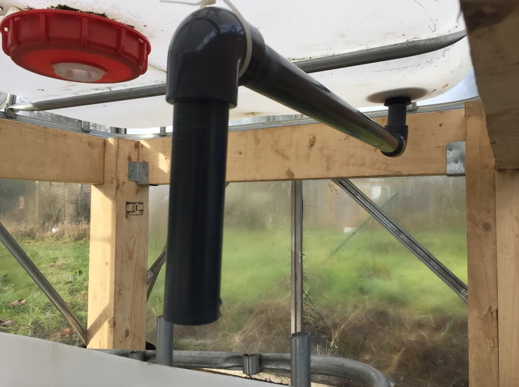 Pipe beneath the grow bed in the aquaponics greenhouse