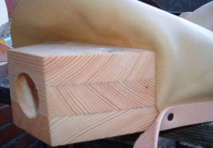 Folding the leather round and making the seal at the nozzle block