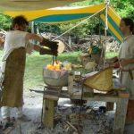 Re-enacters Kormak and Mo hard at work using handmade bellows at their forge