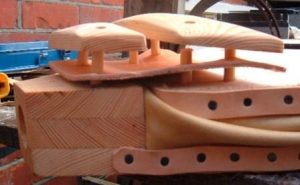 Leather hinge is sandwiched into place
