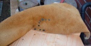 Sealing the leather to the nozzle block with tacks