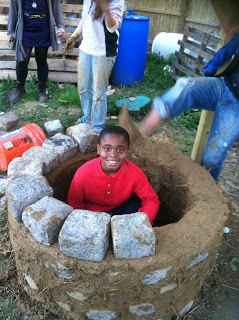 The masonry base of the cob oven takes shape...